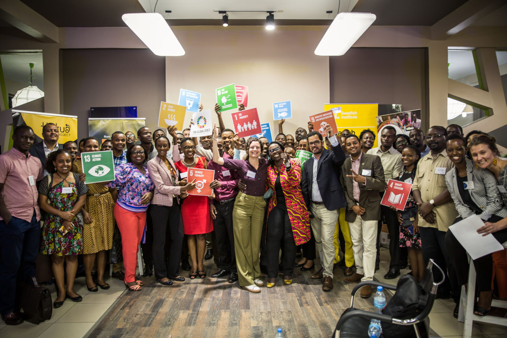 over 30 participants in group picture with symbols of SDGs in their hands