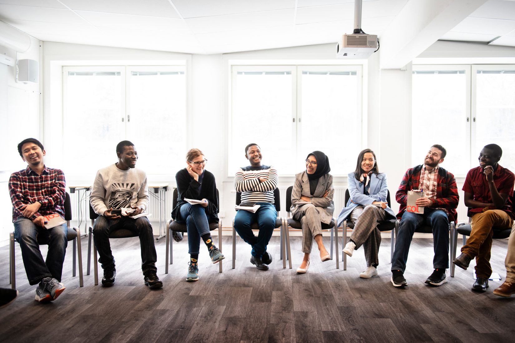 Si Scholarship students sitting on chairs in a classroom