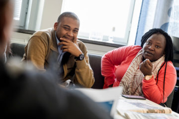 Two participants in discussion with a third person