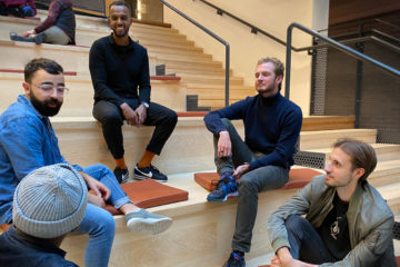Five men sitting in a stair way construction having a discussion. #globalguytalk aims to bring med together and have discussions around topics they seldom speak about. Photo: Swedish Institute