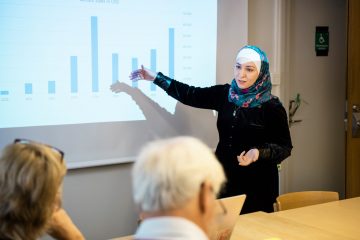 A woman holding a presentation.