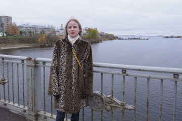 Kvinna på bro i Archangelsk. Det är vinter.