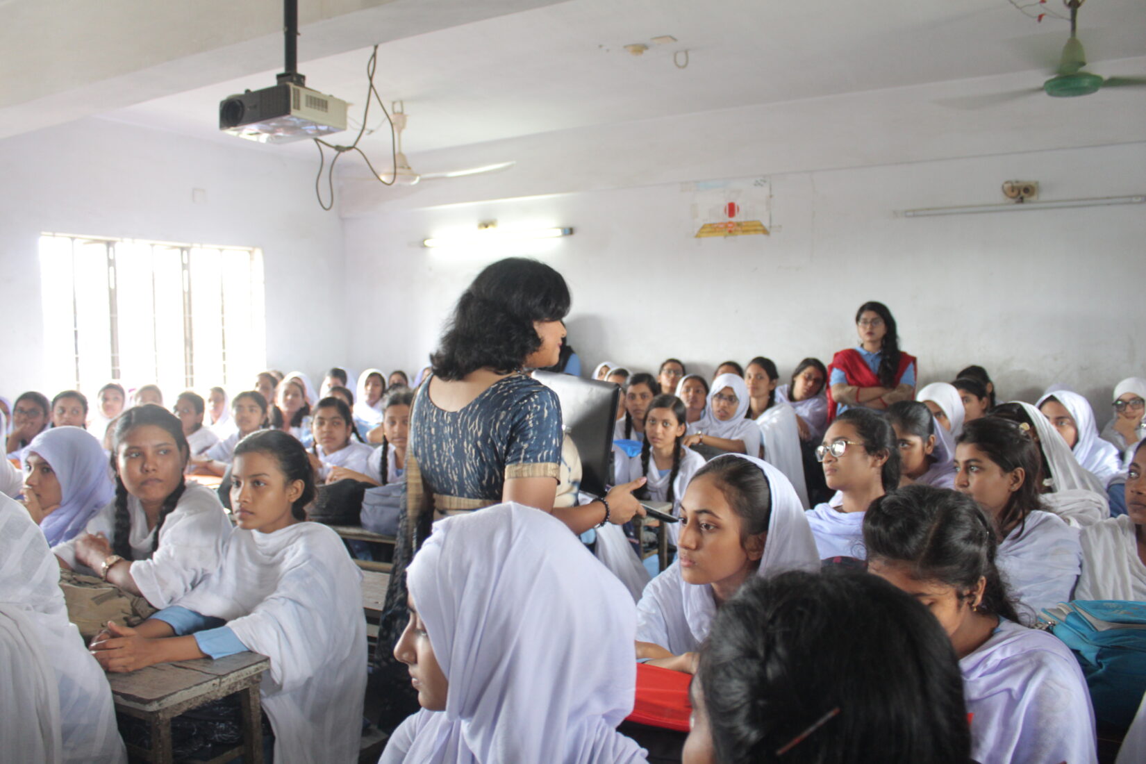 Woman talking to students in a classroom