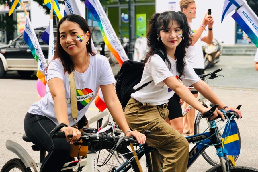 Two women on bikes celebrating Pride