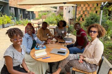 Participants of SIMP Africa sitting around a coffee table.