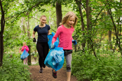 People running picking up litter