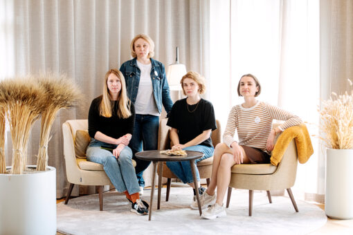 Four women in a discussion around a table.