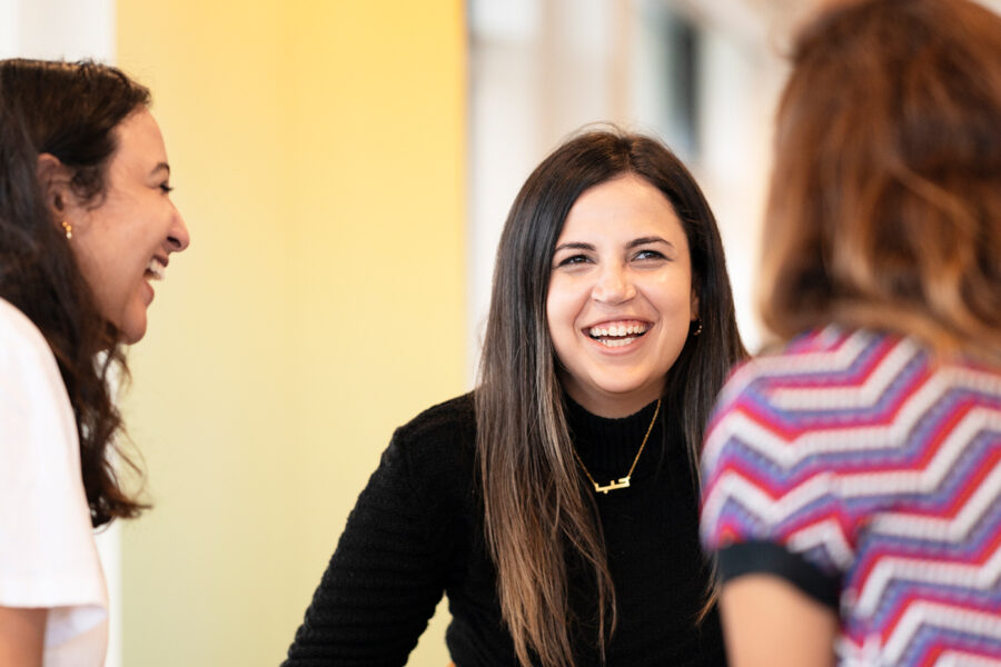 A woman in a discussion with two other women.