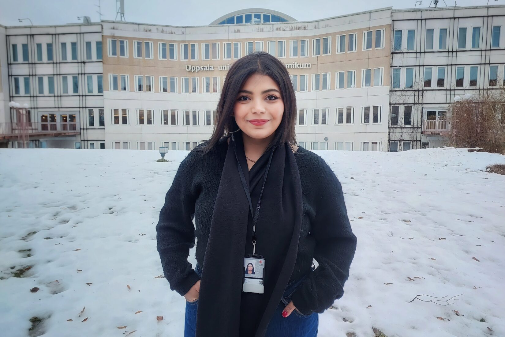 Photo of Aya standing in front of Uppsala university building