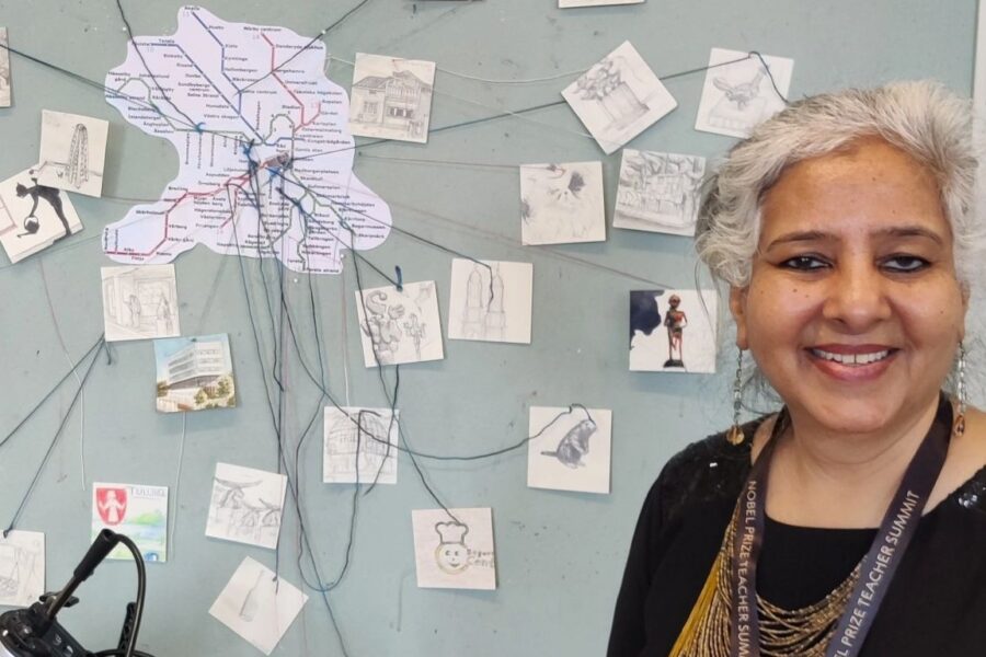 Woman standing in front of a wall with pictures.