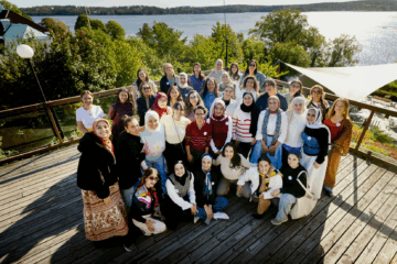 A group photo of 30 participants facing the camera. 