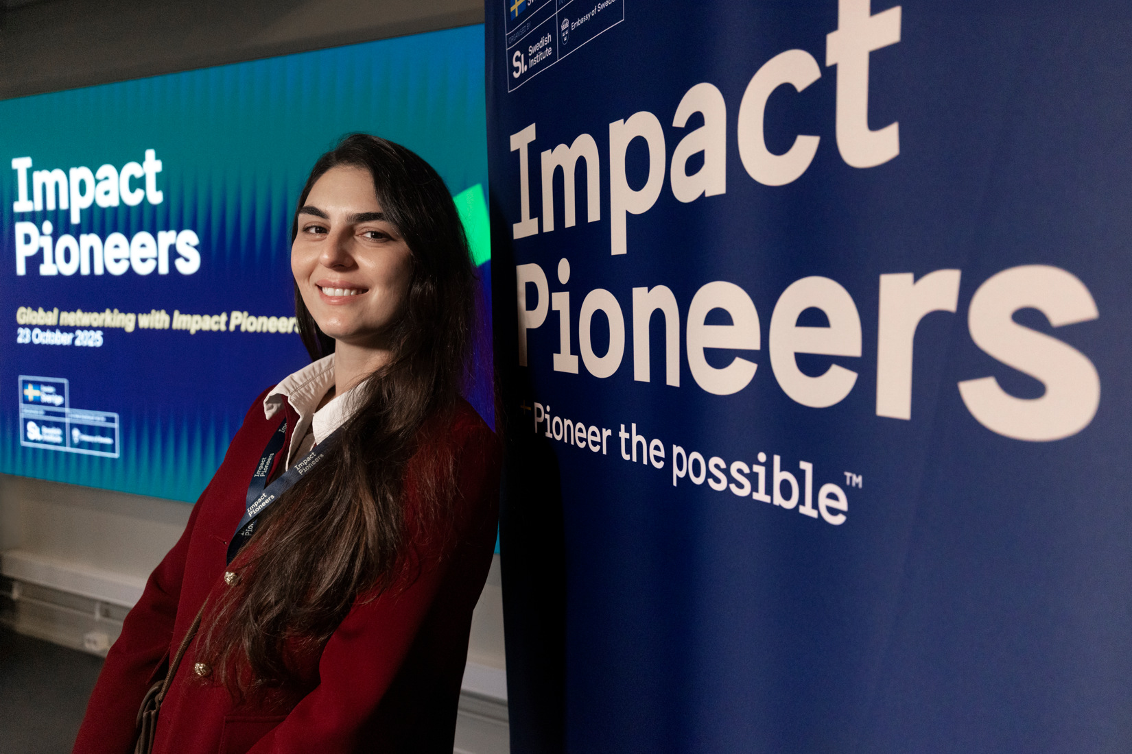 Woman standing against a wall.